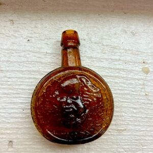 Antique small glass bottle. Brown glass with letting.